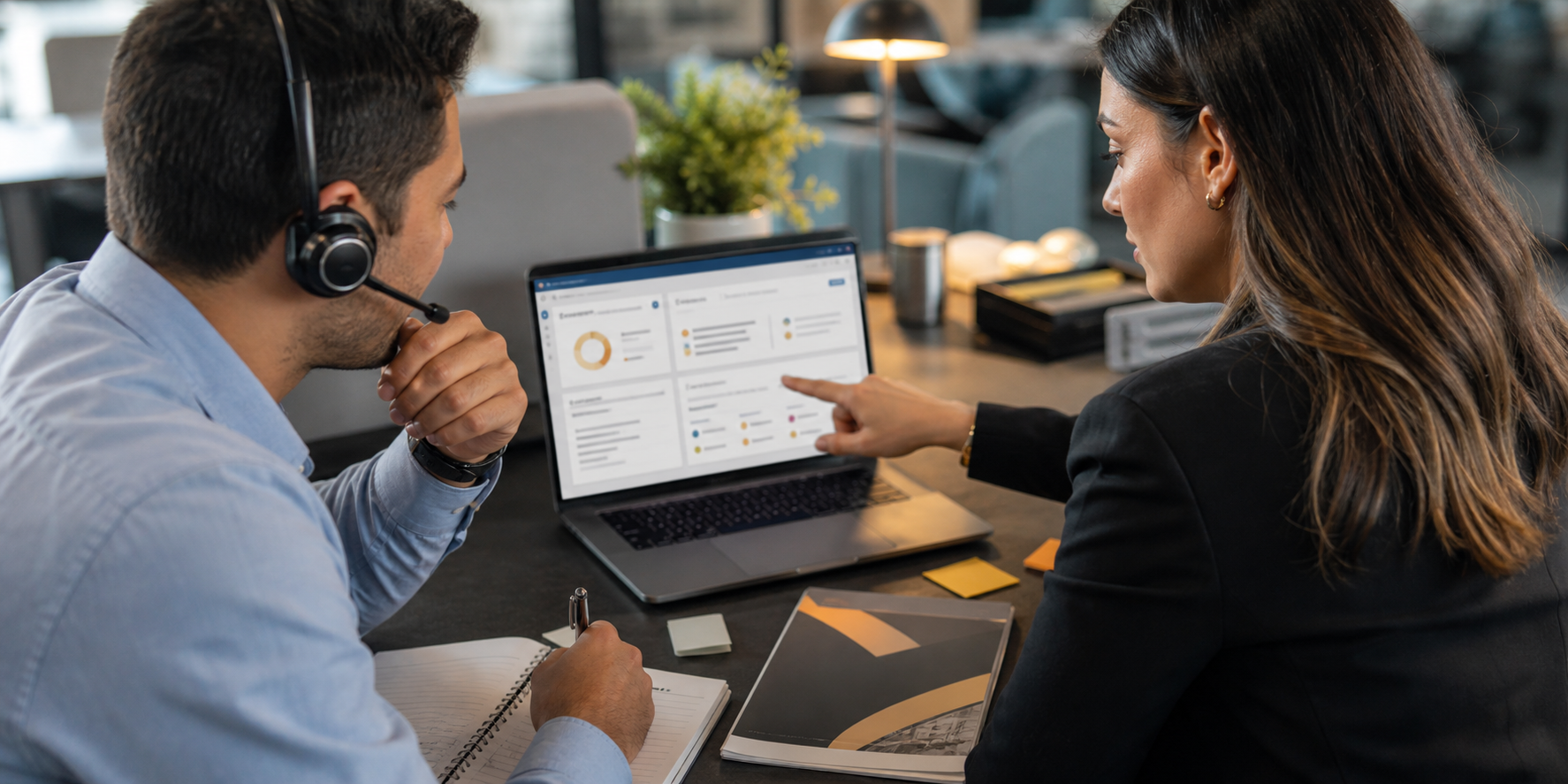 Two Executives Reviewing CRM Data Over Shoulder