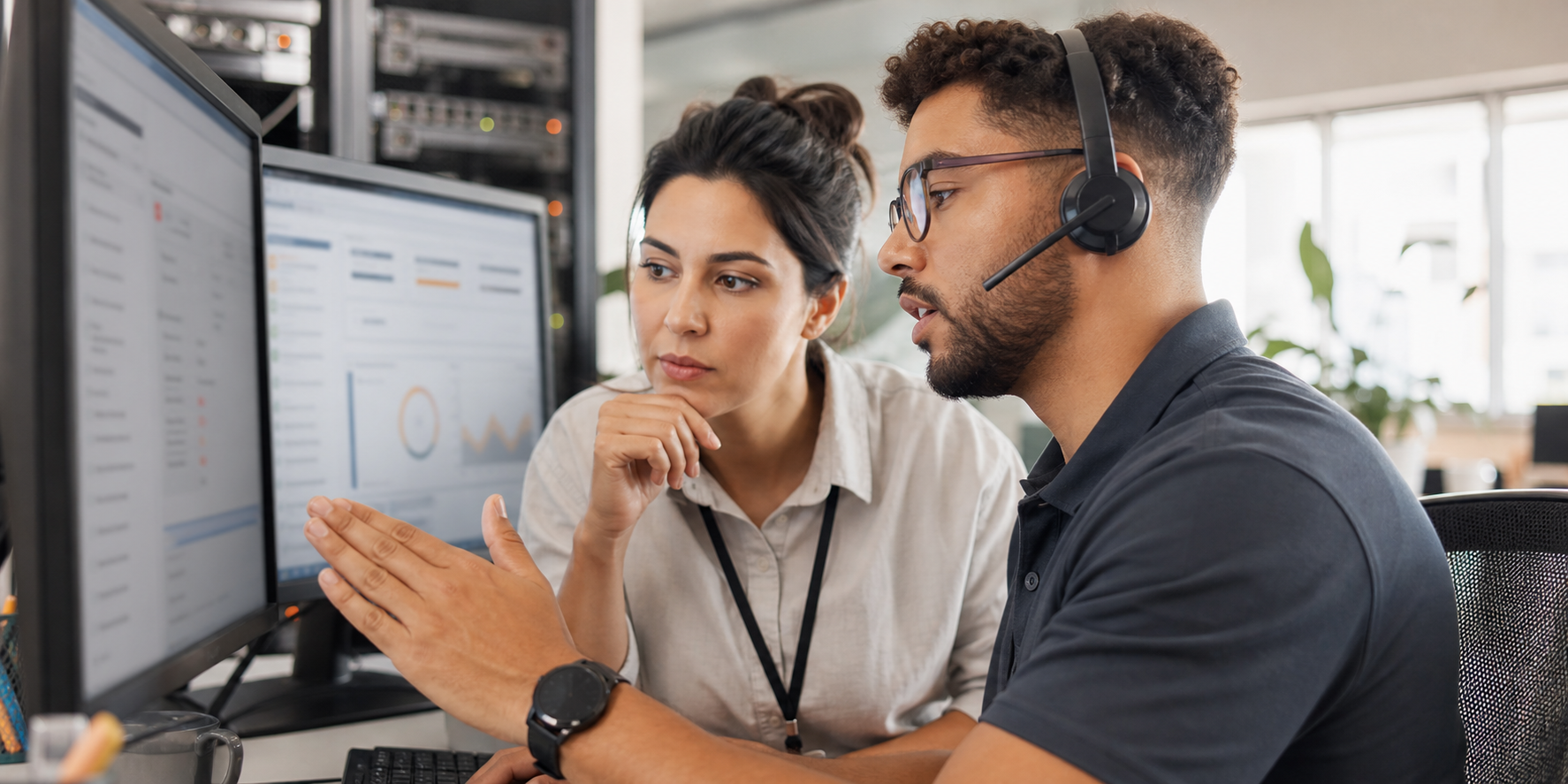 Two IT Analysts Reviewing Priority Ticket Screens